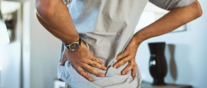 Man holding his low back in pain