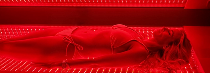 Chiropractic Lutz FL Woman in Red Light Therapy Machine